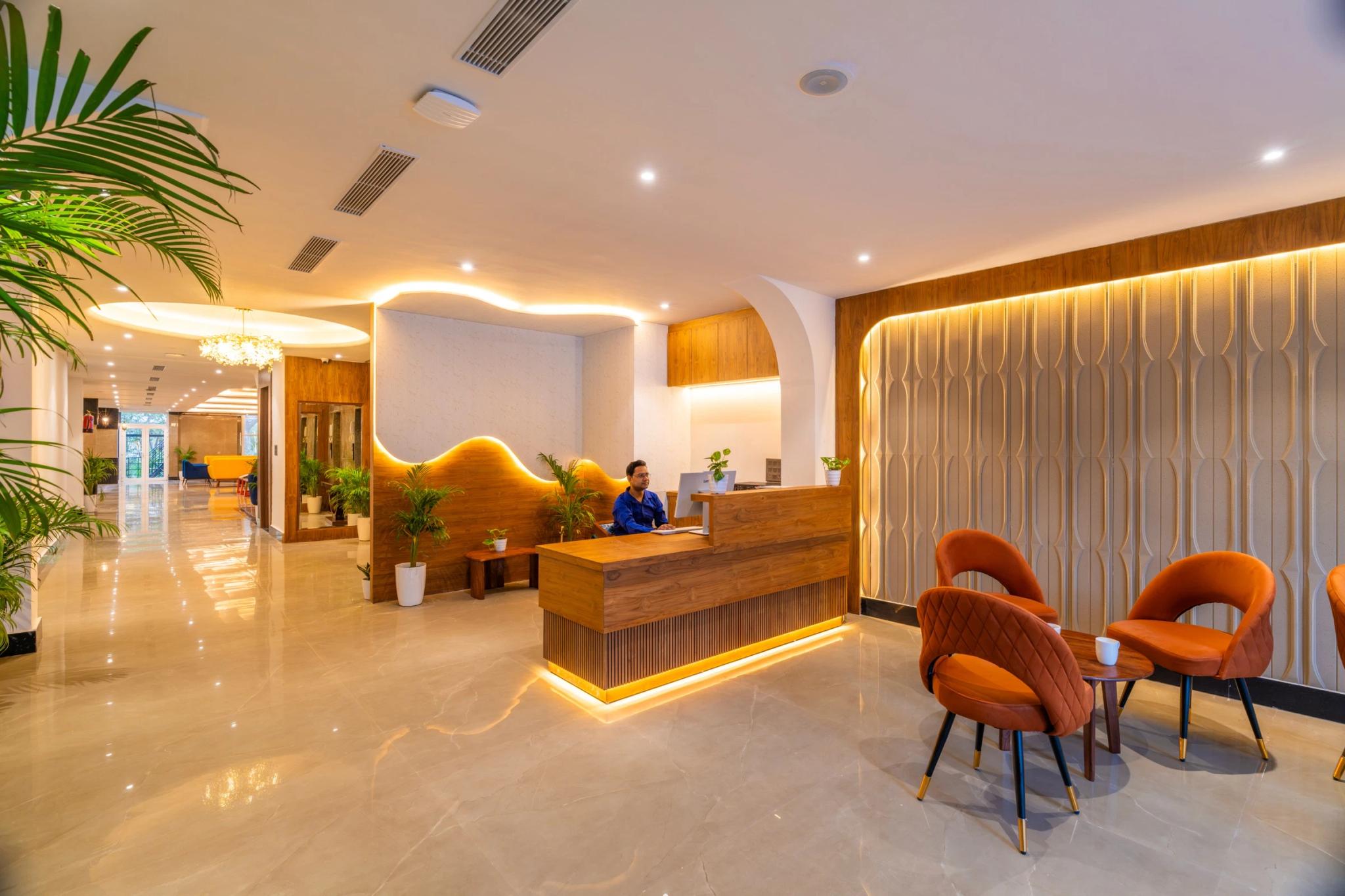 FRAZ Rishikesh lobby with a warm-lit wooden wave wall and reception desk