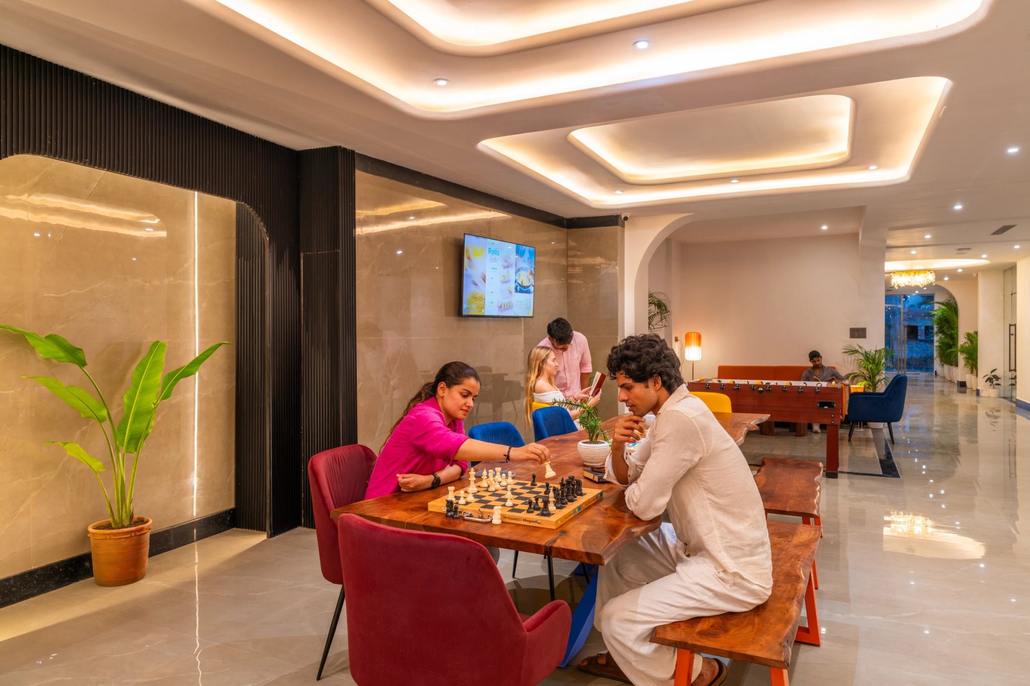 Two guests playing chess in the common area
