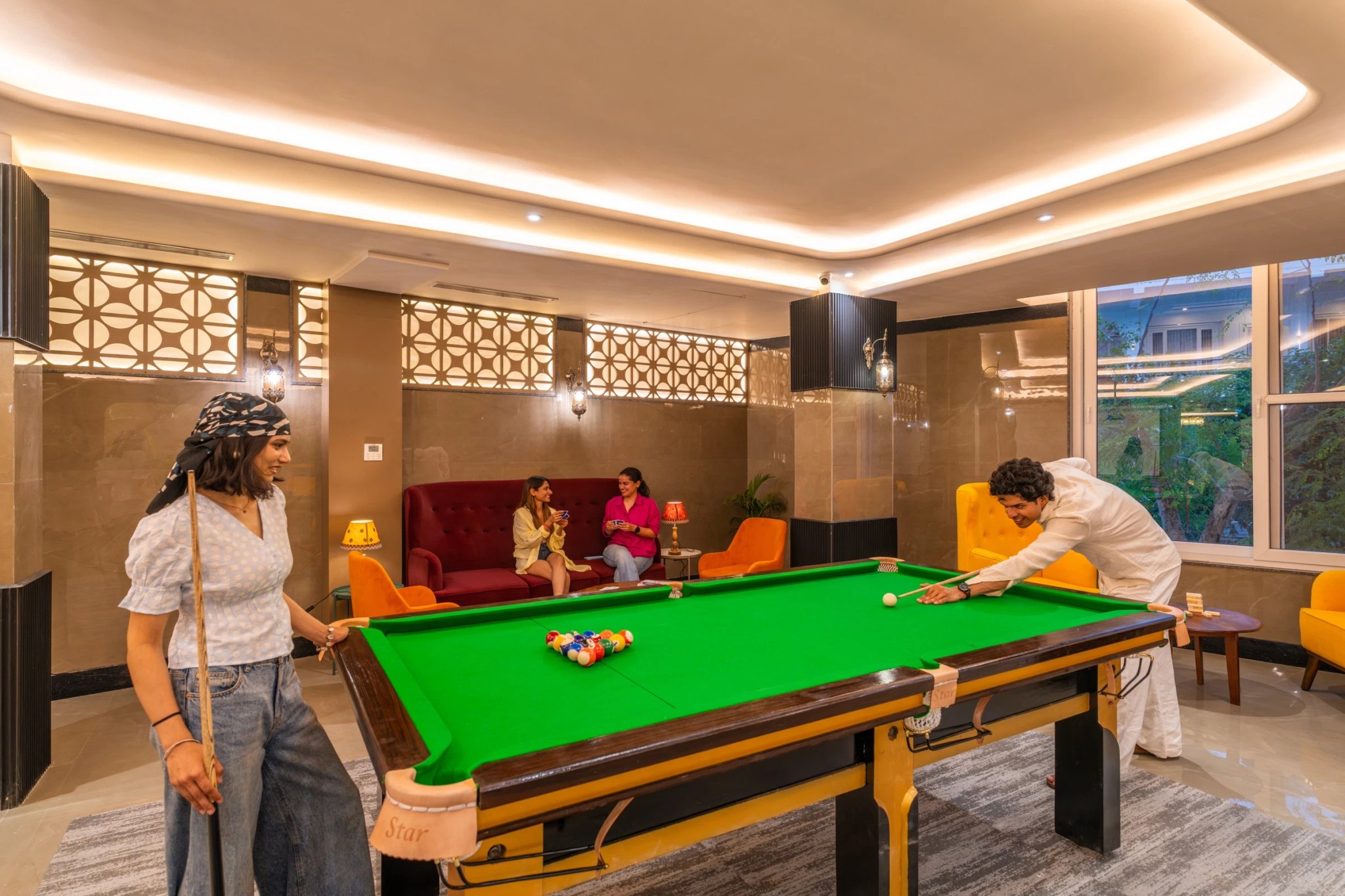 Guests playing pool in the FRAZ gaming zone