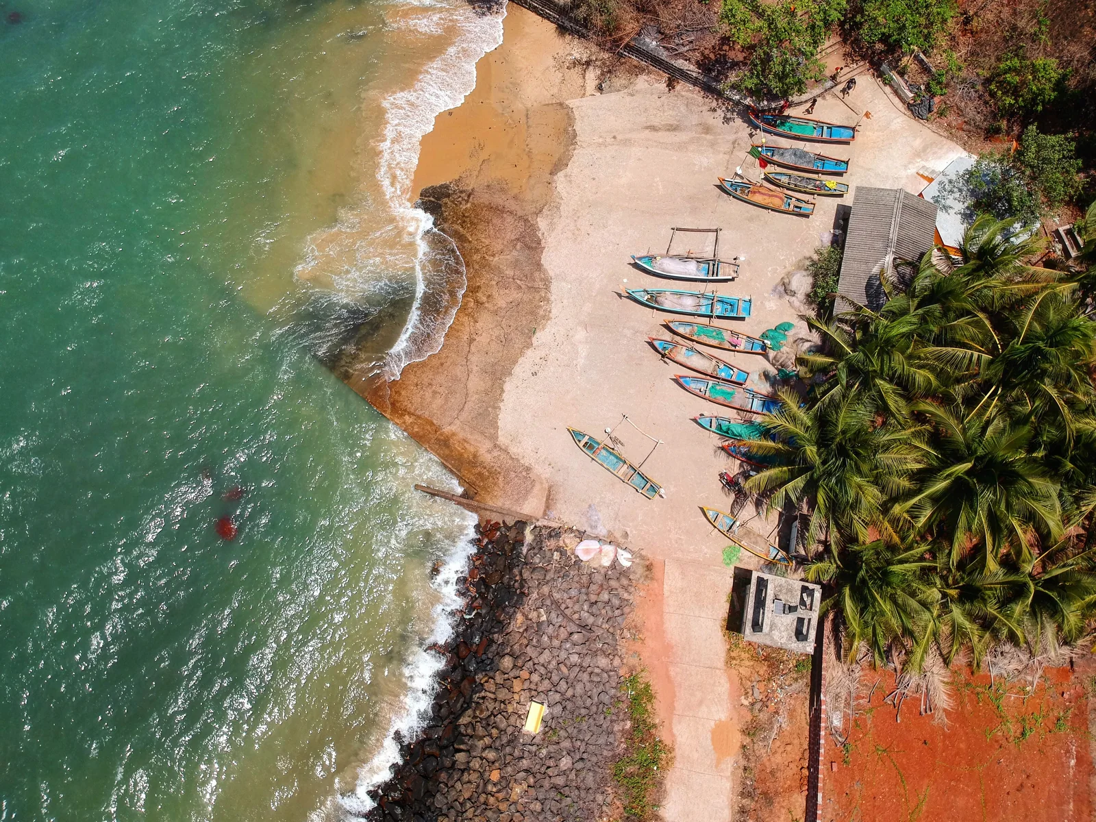 Aerial view of a Goa beach, fishing boats drawn up on the sand